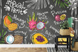 Tropical fruit wallpaper bringing fresh market vibes to modern kitchen with black chalkboard background
