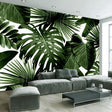 Tropical leaf wallpaper in modern living room showing large Monstera leaves against white wall