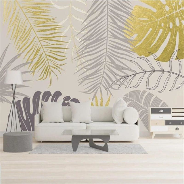 Tropical palm leaves wallpaper in gold and grey creating a luxurious atmosphere in a modern living room