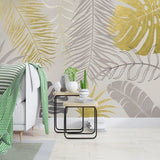 Palm leaves wallpaper in metallic gold and grey tones making a statement in a dining room