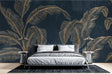 Tropical gold banana leaf wallpaper creating a stunning accent wall in a modern living room with navy and gold decor