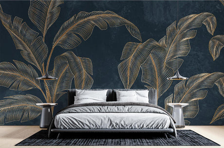 Tropical gold banana leaf wallpaper creating a stunning accent wall in a modern living room with navy and gold decor