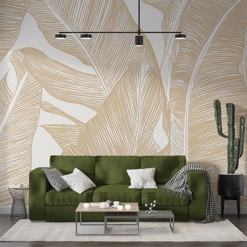 Tropical banana leaf wallpaper in gold tones creating a warm atmosphere in a modern living room setting