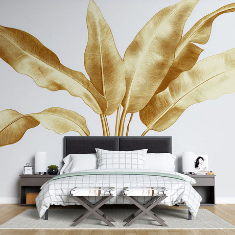 Tropical leaf wallpaper with golden banana leaves creating a bright, modern look in a sunlit living room