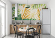 Tropical leaf wallpaper with gold accents creating a modern living room focal point