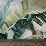 Tropical banana leaf wallpaper mural creating a fresh statement wall in a modern living room with white furniture