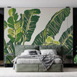Tropical banana leaf wallpaper creating a fresh backdrop in a modern living room with natural light
