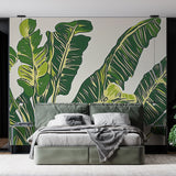 Tropical banana leaf wallpaper creating a fresh backdrop in a modern living room with natural light
