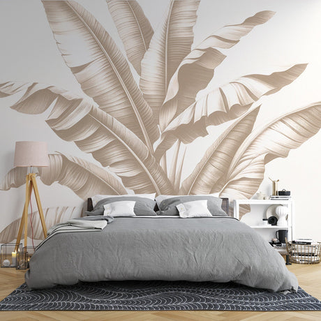 Tropical banana leaf wallpaper in beige tones creating a serene atmosphere in a modern living room with natural light