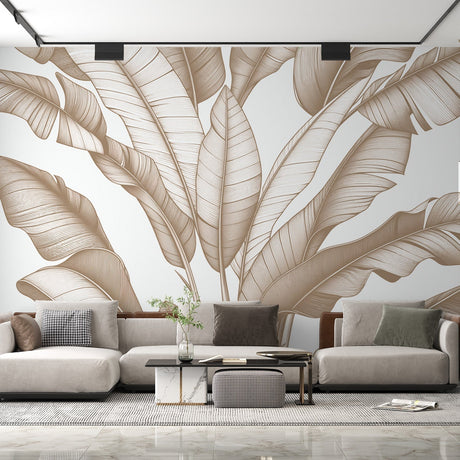 Tropical leaf wallpaper with beige banana leaves creating a calm atmosphere in a modern living room with natural light