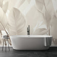 Tropical leaf wallpaper creating a serene atmosphere in a modern living room with beige and cream tones
