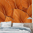 Tropical banana leaf wallpaper in orange creates a warm and inviting modern living room atmosphere