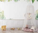 Tropical lion wallpaper creating a bold statement in modern living room with green monstera leaves
