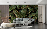 Banana leaf wallpaper adding depth to a sleek dining room with gold accents