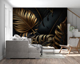 Tropical black and gold leaf wallpaper in modern living room with tall windows and mid-century furniture
