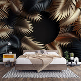 Tropical palm leaf wallpaper with gold and black design creating drama in a modern living room setting