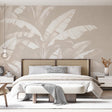Tropical leaf wallpaper in modern minimalist living room showing large-scale banana leaves in white against soft beige