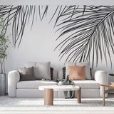 Minimalist palm leaf wallpaper creating a fresh modern look in a bright living room with white sofa and natural light