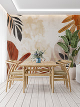 Home office featuring tropical leaf mural wallpaper in warm earthy tones