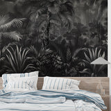 Home office space with sophisticated black and white palm leaf mural creating focus