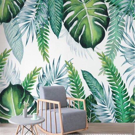 Tropical Monstera leaf wallpaper in bright modern living room with white sofa and natural light