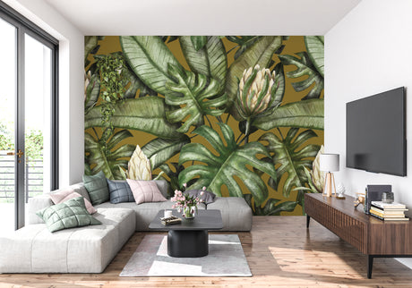 Tropical Monstera leaf wallpaper in modern living room with gold accents and green plants