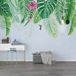 Tropical leaf wallpaper with monstera and hummingbird creating a serene atmosphere in a modern living room