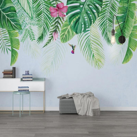 Tropical leaf wallpaper with monstera and hummingbird creating a serene atmosphere in a modern living room
