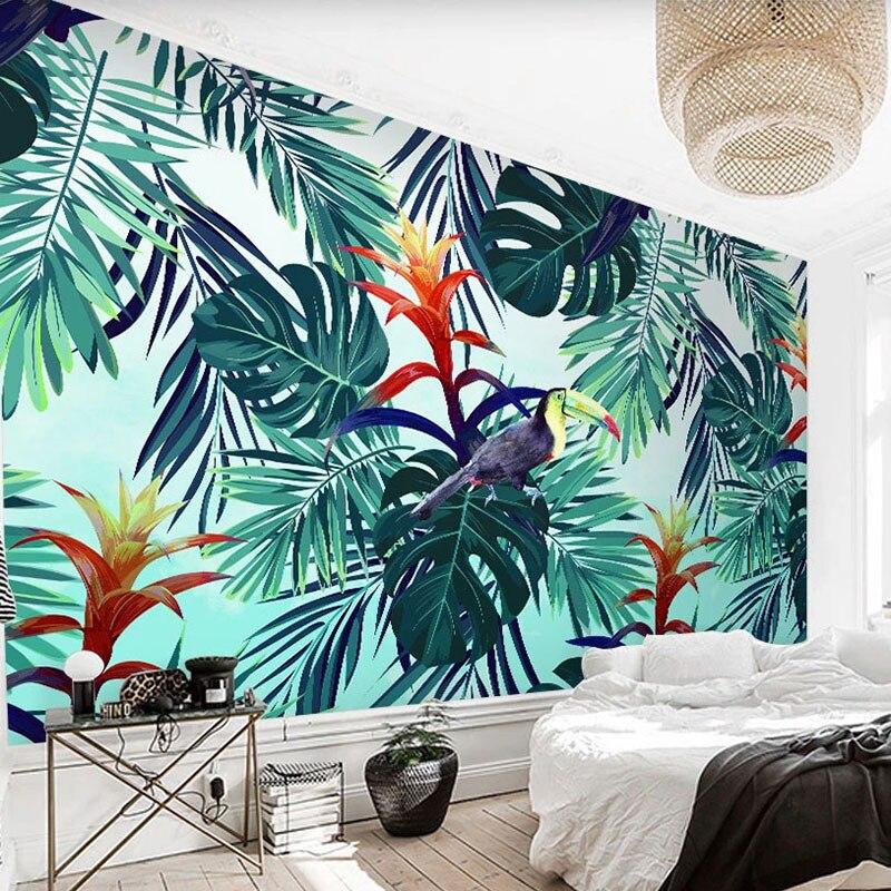 Toucan and monstera leaf wallpaper brightening up a cozy bedroom space