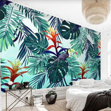 Toucan and monstera leaf wallpaper brightening up a cozy bedroom space