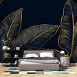 Tropical leaf wallpaper in navy and gold creating a stunning accent wall in a modern living room with high ceilings