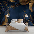Tropical navy and gold palm leaf wallpaper creating a stunning backdrop in a modern living room with soft lighting