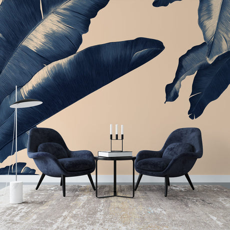 Tropical palm leaf wallpaper in navy blue creating a bold statement wall in a modern living room with natural light