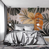 Orange Monstera leaf wallpaper in modern living room, creating warm tropical atmosphere