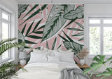 Pink tropical wallpaper bringing warmth to an entrance hall with palm leaf design