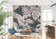 Pink and grey Monstera leaf wallpaper in a modern living room creating a calm, sophisticated atmosphere