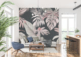 Pink and grey Monstera leaf wallpaper in a modern living room creating a calm, sophisticated atmosphere