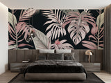 Tropical leaf mural in soft pink tones brightening up a cozy bedroom space