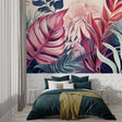 Pink and navy Monstera leaf wallpaper in modern living room with gray sofa and natural light