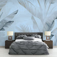 Tropical palm leaf wallpaper in blue tones creating a serene atmosphere in a modern living room with natural light