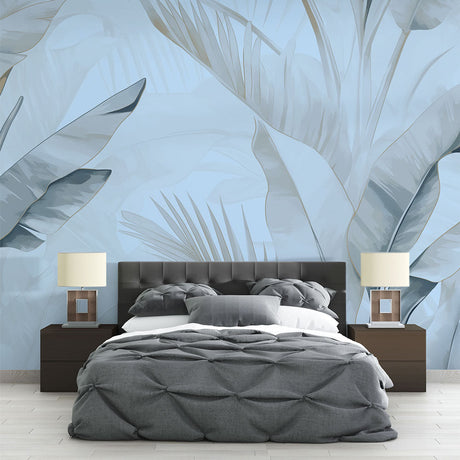 Tropical palm leaf wallpaper in blue tones creating a serene atmosphere in a modern living room with natural light