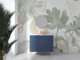 Botanical wallpaper with soft green leaves in minimal bedroom setting with white bedding