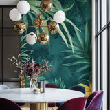Green palm leaf wallpaper bringing tropical vibes to a cozy bedroom setting