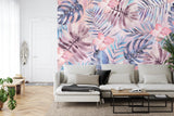 Tropical wallpaper with pink flowers and monstera leaves in a bright modern living room