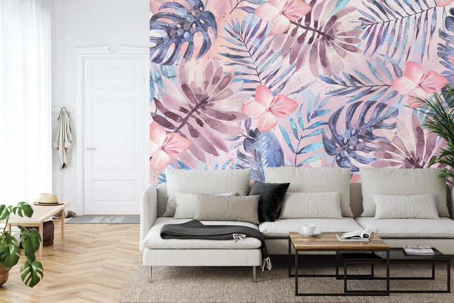 Tropical wallpaper with pink flowers and monstera leaves in a bright modern living room