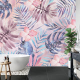 Pink floral wallpaper with monstera leaves in a sunny home office