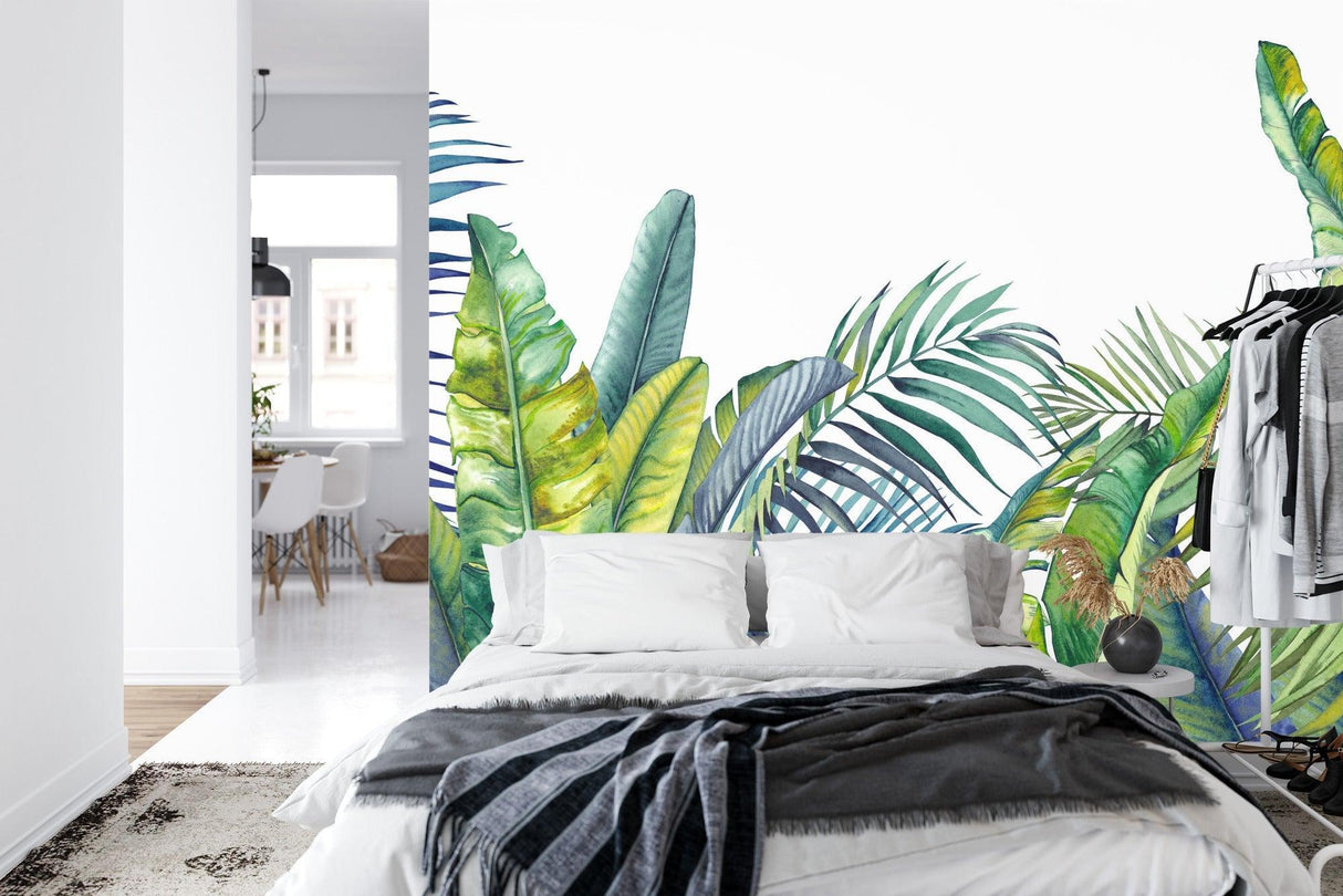 Watercolor palm leaves mural adding natural charm to bedroom with soft lighting