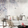 Tropical palm leaf wallpaper in modern living room showing watercolor style fronds in blue-grey tones