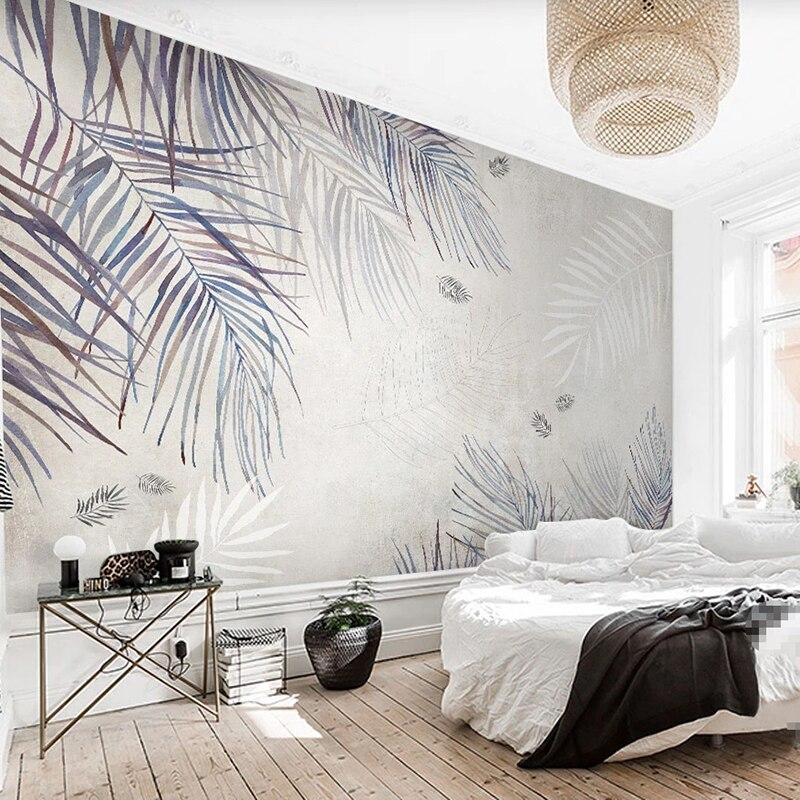 Tropical wall mural featuring soft blue-grey palm leaves in home office setting