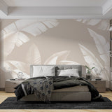 Tropical banana leaf wallpaper in modern living room, white leaves on beige creating a bright, airy atmosphere